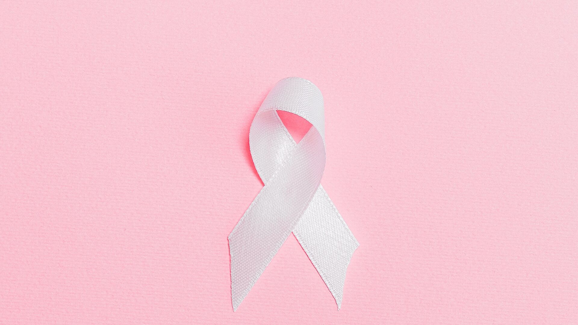 Pink ribbon on pink surface 3900428